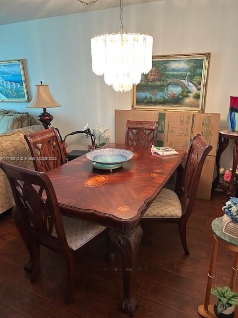 dining area featuring a notable chandelier and wood-type flooring