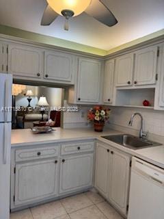 7500 NW 5th Pl Unit 103, Margate, FL 33063 - kitchen featuring white dishwasher, freestanding refrigerator, light tile patterned floors, light countertops, and tasteful backsplash