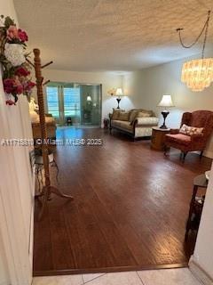 7500 NW 5th Pl Unit 103, Margate, FL 33063 - living room with wood finished floors and a chandelier