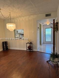 7500 NW 5th Pl Unit 103, Margate, FL 33063 - unfurnished living room with wood finished floors and a chandelier