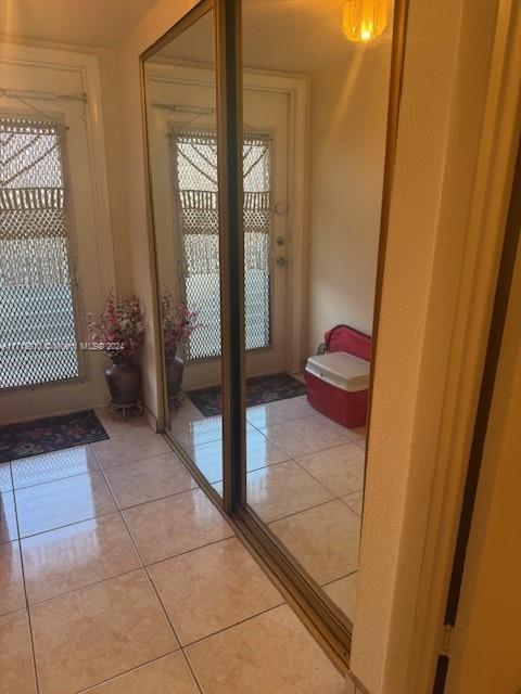 doorway to outside with light tile patterned floors