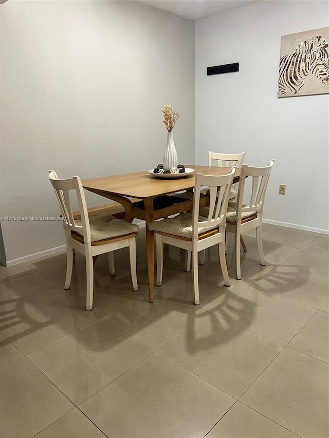 dining space with tile patterned flooring