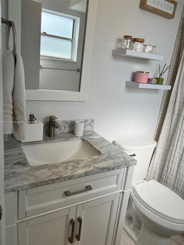 bathroom featuring vanity and toilet