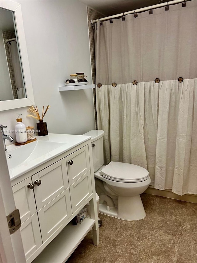 bathroom featuring vanity, toilet, and walk in shower