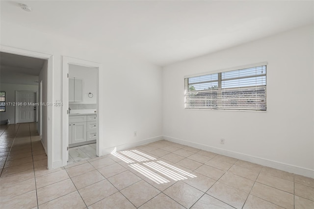 spare room featuring light tile patterned flooring