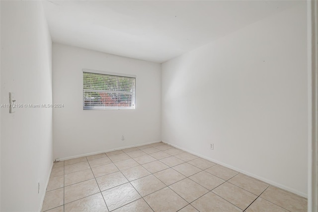 unfurnished room with light tile patterned floors