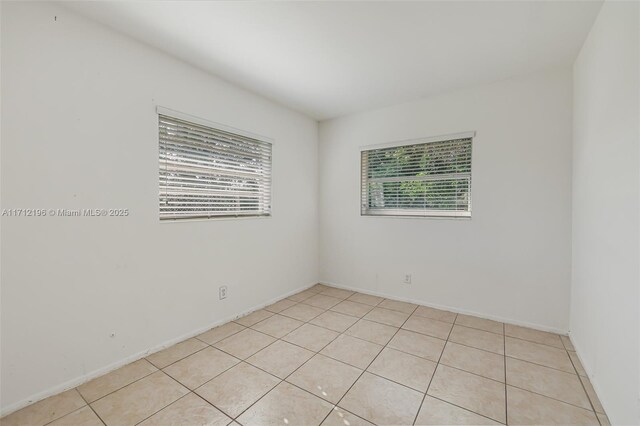 unfurnished bedroom featuring light tile patterned floors and a closet