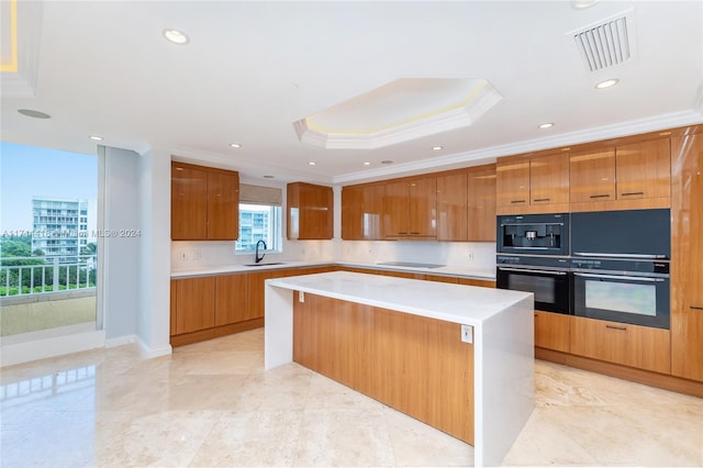 kitchen featuring electric cooktop, a raised ceiling, sink, ornamental molding, and a kitchen island