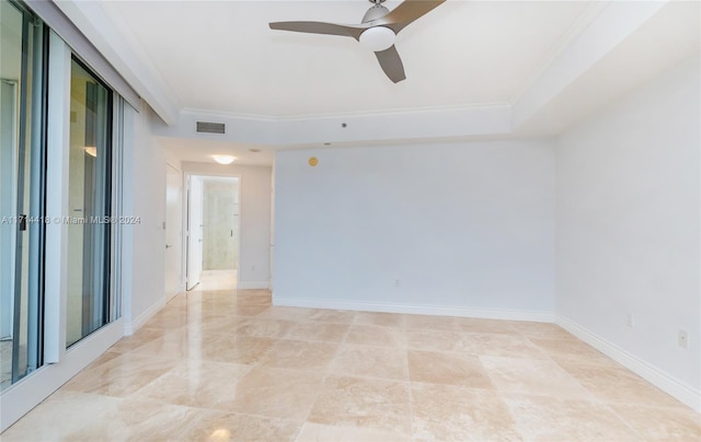 spare room featuring ceiling fan and crown molding