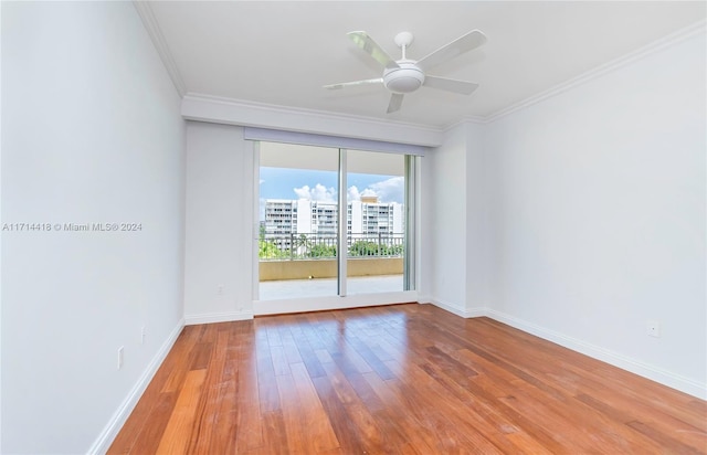 unfurnished room featuring ceiling fan, light wood-type flooring, and ornamental molding