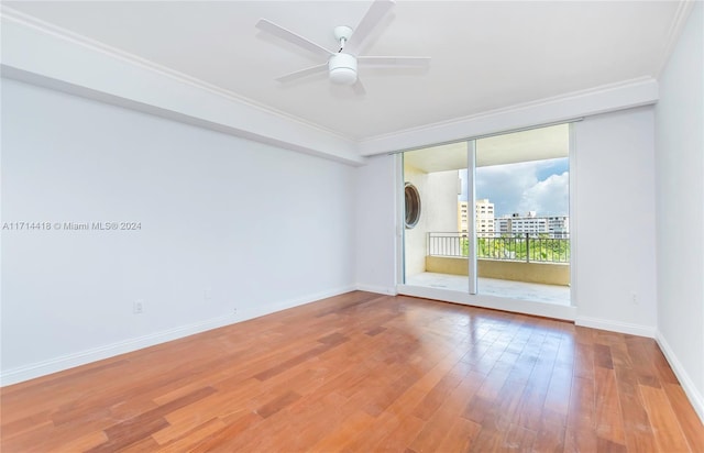 spare room featuring hardwood / wood-style flooring, ceiling fan, and crown molding