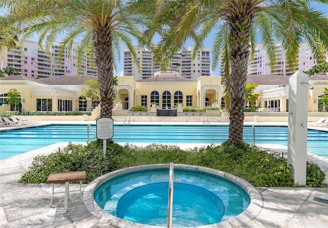 view of pool with a hot tub