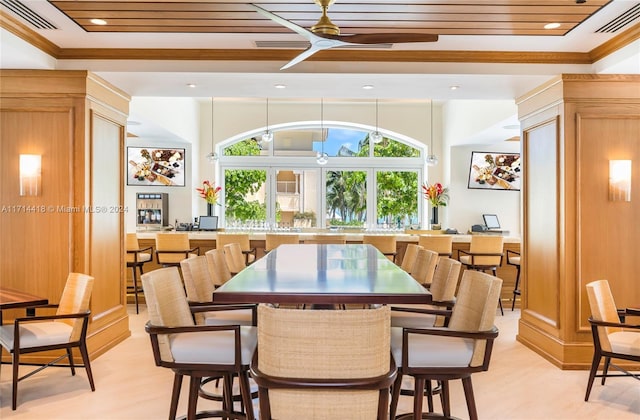 dining space with ceiling fan and crown molding