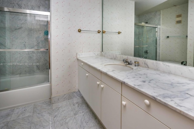 bathroom featuring vanity and combined bath / shower with glass door