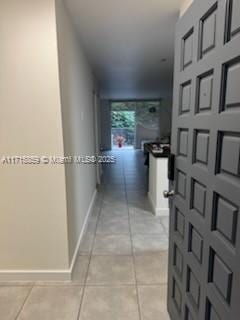 hallway with light tile patterned flooring