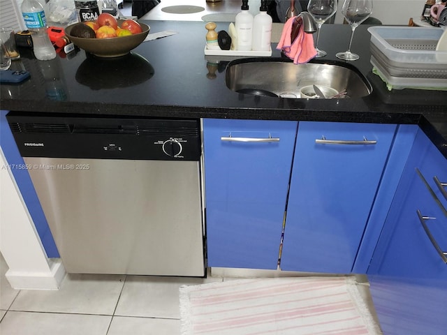 kitchen with sink, light tile patterned floors, dishwasher, and blue cabinets