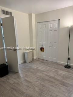 interior space with light wood-type flooring and a closet