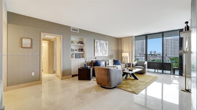 living room with floor to ceiling windows, built in shelves, and light tile patterned floors