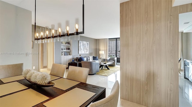 dining space featuring expansive windows and an inviting chandelier