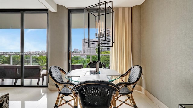 dining room with expansive windows and a notable chandelier