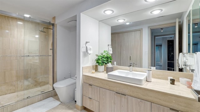 bathroom featuring tile patterned floors, vanity, toilet, and an enclosed shower