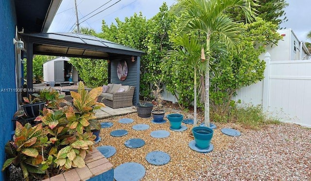 view of patio with a gazebo and a shed