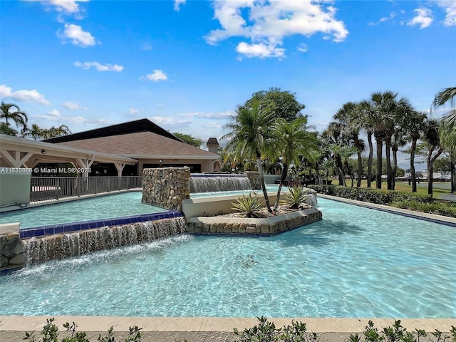 view of swimming pool featuring pool water feature