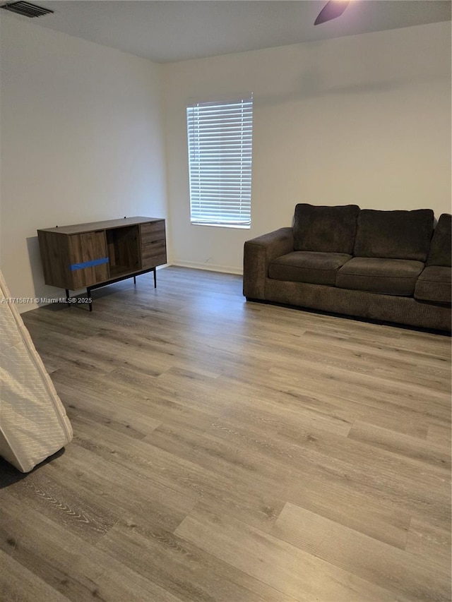 living room featuring ceiling fan and light wood-type flooring