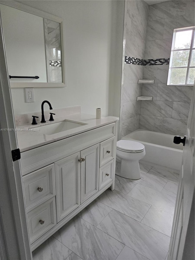 full bathroom with tiled shower / bath combo, toilet, and vanity