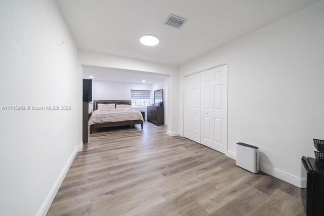 unfurnished bedroom featuring wood-type flooring and a closet