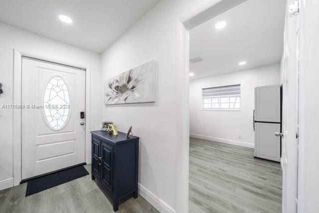 foyer entrance with light hardwood / wood-style flooring