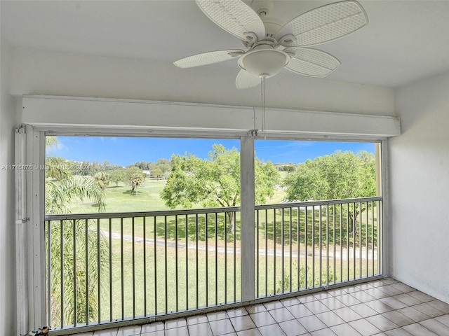 unfurnished sunroom featuring ceiling fan