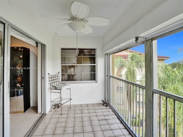 unfurnished sunroom featuring ceiling fan