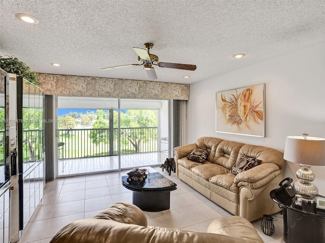 tiled living room with ceiling fan and a textured ceiling