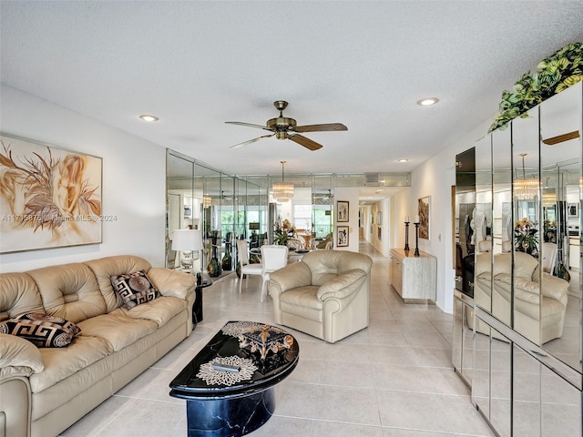 tiled living room featuring a textured ceiling and ceiling fan