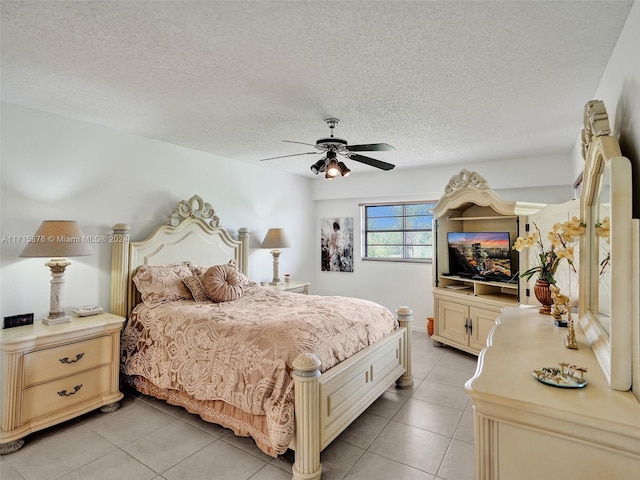 tiled bedroom featuring ceiling fan and a textured ceiling