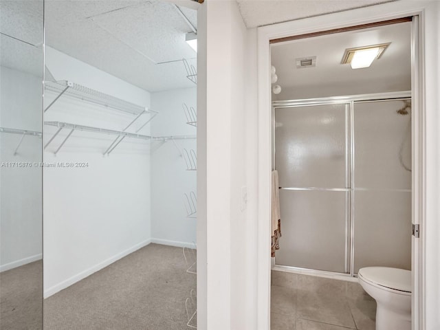 bathroom featuring toilet and an enclosed shower