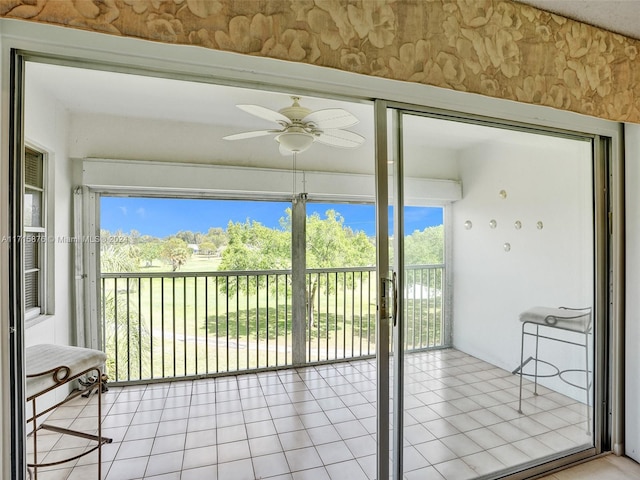 unfurnished sunroom with ceiling fan