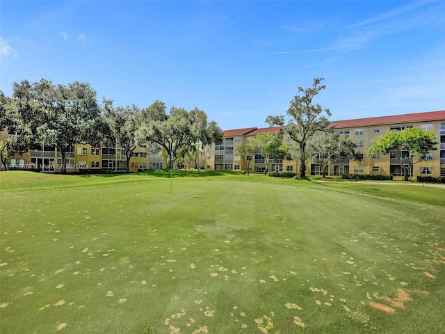 view of property's community with a yard