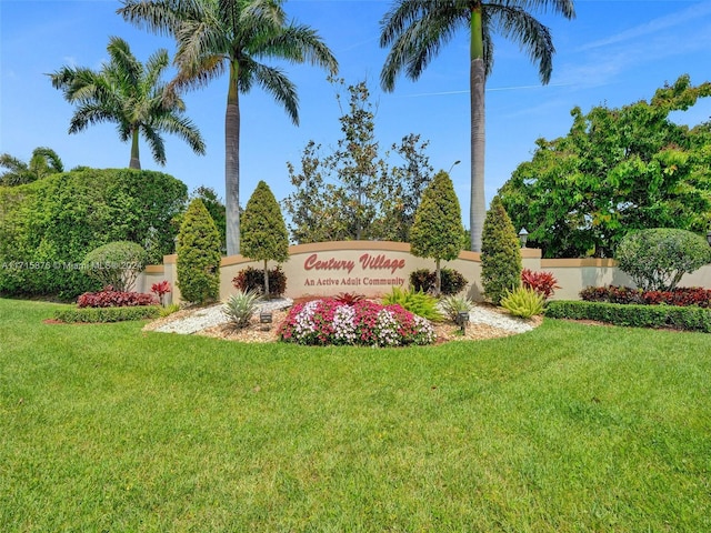 community sign featuring a yard