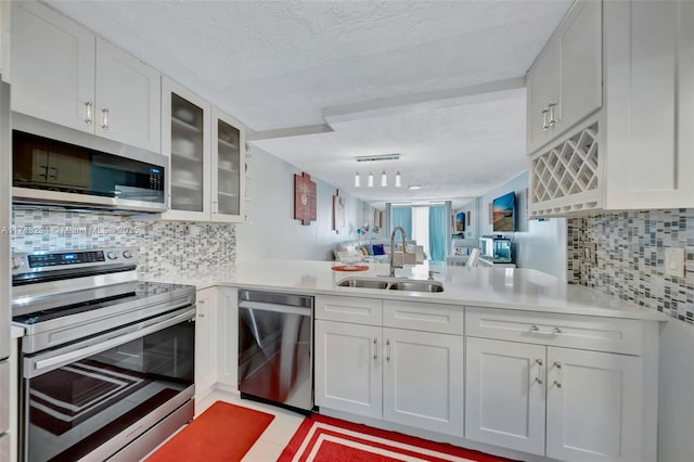 kitchen with sink, white cabinets, appliances with stainless steel finishes, and a textured ceiling