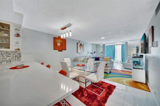 tiled dining room with a textured ceiling