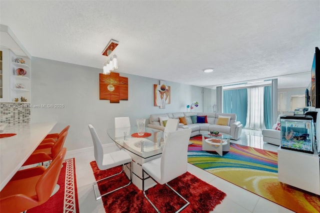 tiled dining area featuring a textured ceiling