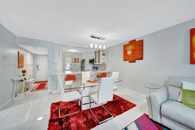 dining room with sink and light tile patterned floors