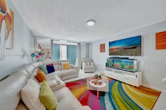 living room featuring a textured ceiling and tile patterned flooring