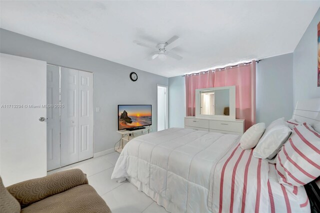 bedroom with light tile patterned flooring, a closet, and ceiling fan