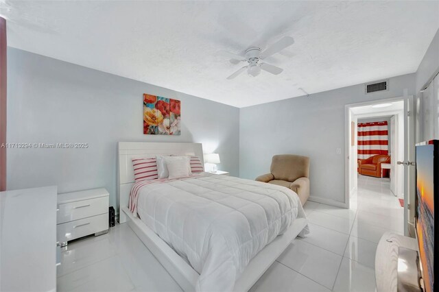 tiled bedroom with ceiling fan