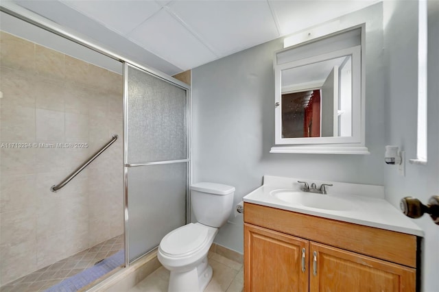 bathroom with toilet, vanity, walk in shower, and tile patterned flooring