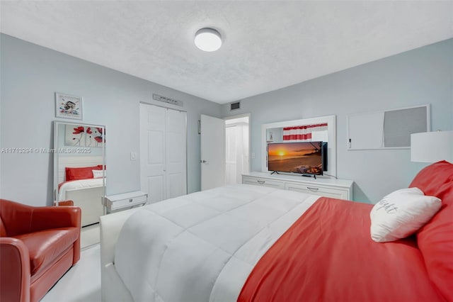 bedroom featuring a textured ceiling and a closet