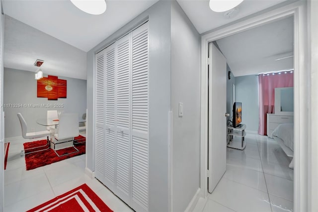 hall featuring light tile patterned floors